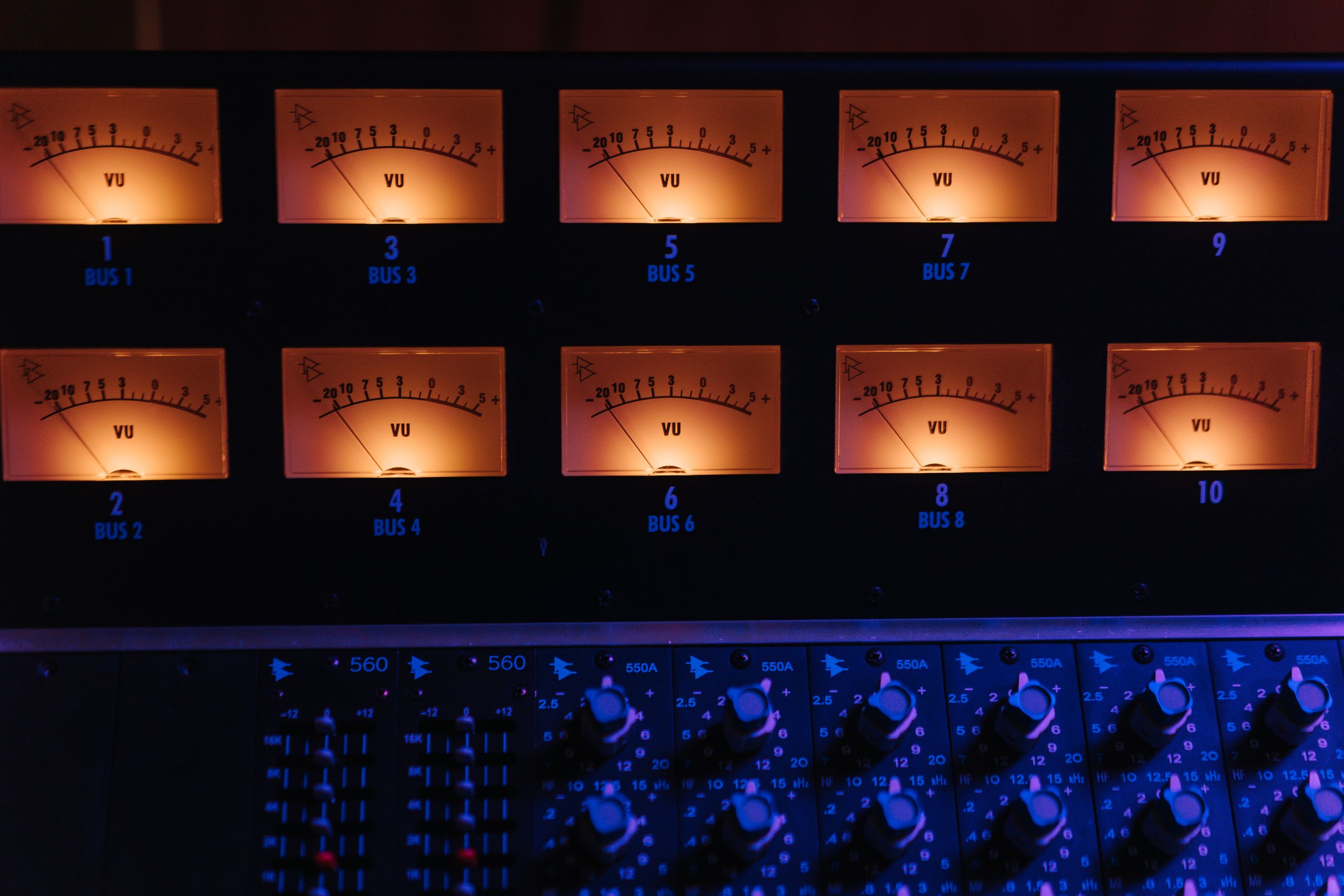 Lit VU meters on a studio mixing console